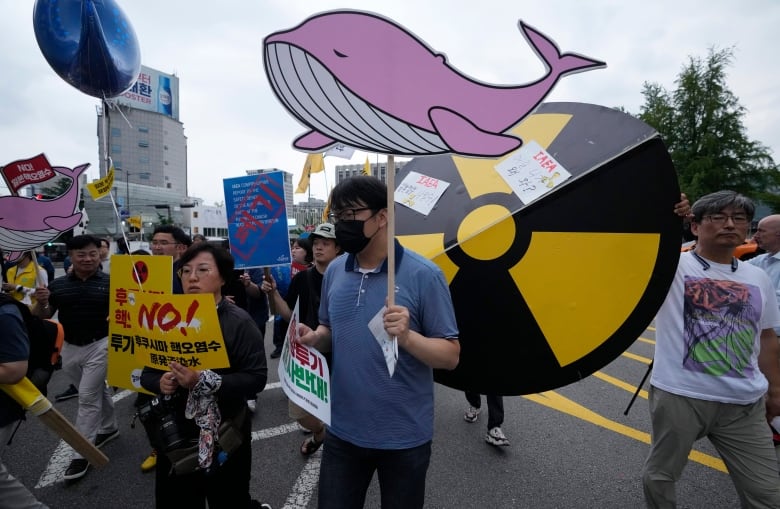 Protesters march carrying flags