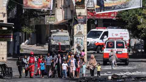 People flee the Jenin refugee camp in the West Bank during an Israeli military operation