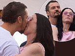 Katy Perry and Orlando Bloom share a passionate kiss as they watch Bruce Springsteen in London