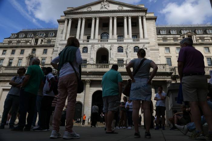 Tourists gather outside the Bank of England