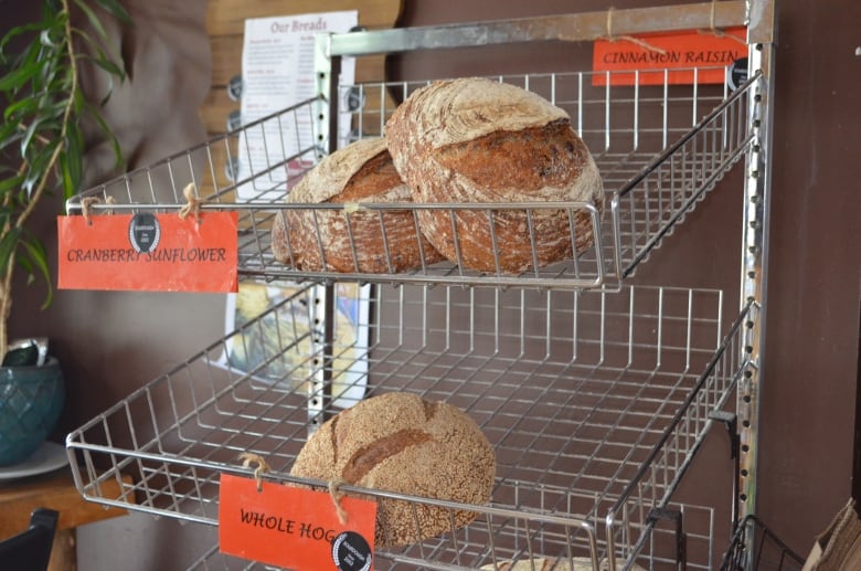 Both Hands Pizzeria and Bakery's rack of baked loaves of bread.