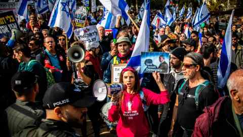 Protesters wave flags and hold placards during this month’s demonstration