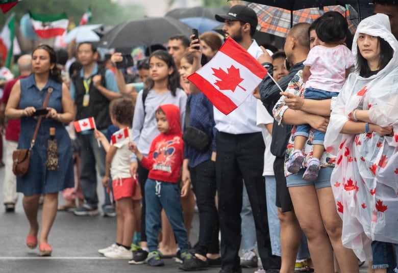 Members of a crowd are seen during a Canada Parade event in Montreal.