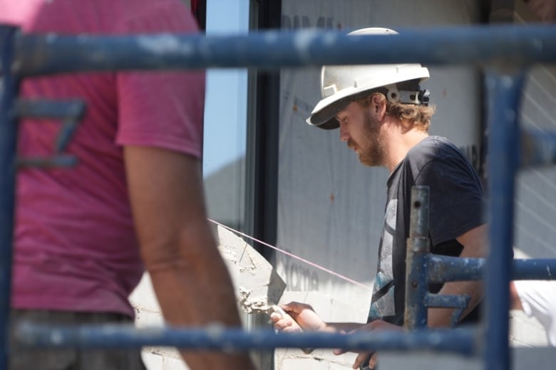 A bricklayer working on a house