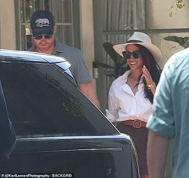 Prince Harry and Meghan Markle hold hands and share a laugh and joke together in Santa Barbara