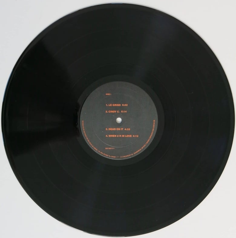 A black 33 and a third album with orange lettering on a grey label.