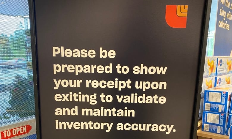 A sign warns customers it is conducting receipt checks. 