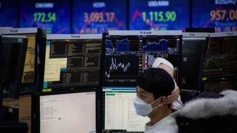 A South Korean dealer monitors stocks