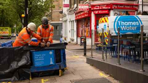 Maintenance engineers work at a Thames Water incident site in London