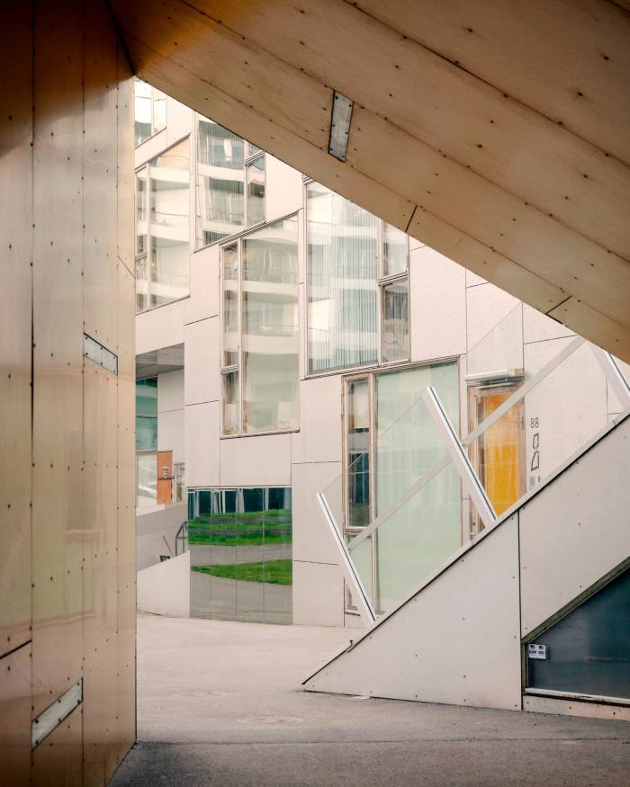 Looking through a triangular sheltered walkway onto a courtyard at 8Tallet