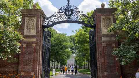 People walk through the gate on Harvard Yard at the Harvard University