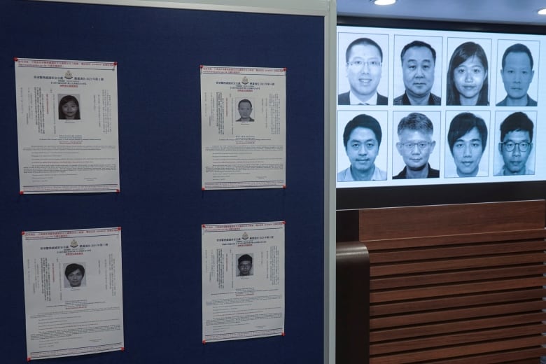 A wall with black and white mugshots.