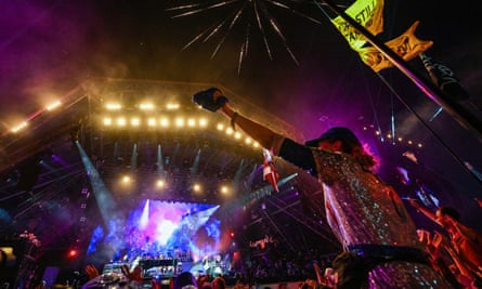 The crowd watch Sir Elton John perform on stage at Glastonbury in June 2023