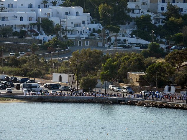 Dozens of students lined a road leading to the island's port as the bodies of Andrew O'Donnell and Max Wall, both 18, were taken on to a ferry