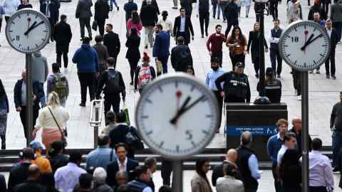 Workers move about Canary Wharf