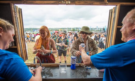 WaterAid volunteers provide festivalgoers with free water at the Glastonbury festival in 2022.