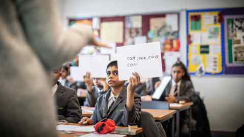 Children using white boards in a classroom