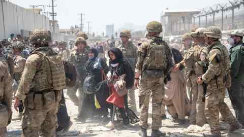 A handout released by the British Ministry of Defence shows members of the UK and US armed forces working at Kabul Airport in August 2021