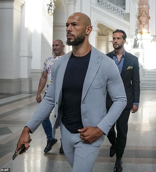 Andrew Tate, left, and his brother Tristan walk inside the the Court of Appeal building in Bucharest, Romania, on Tuesday