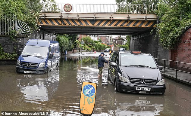 Two cars abandoned following heavy rain in Levenshulme, Manchester yesterday