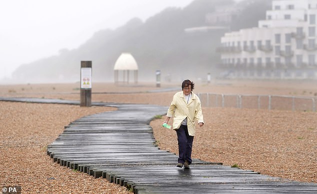 Beach-goers, like this one in Folkestone, Kent, are also told to expect large waves along the coast