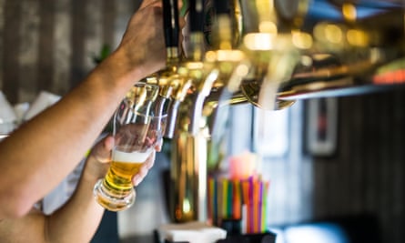 Barman hand pouring draught lager