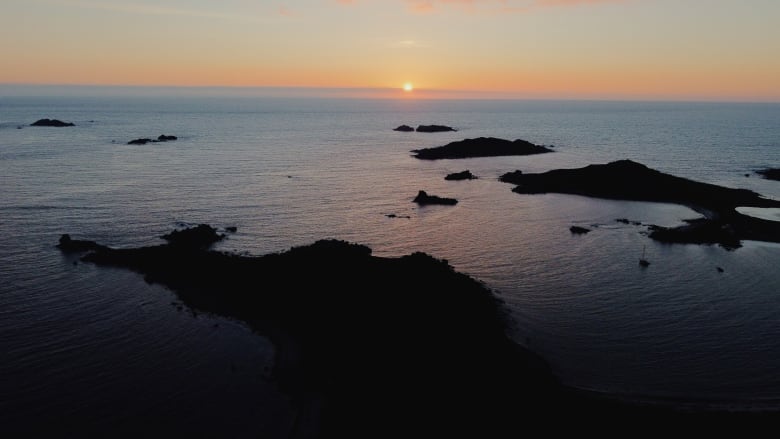 Several small islands at dusk, pictured from above. 