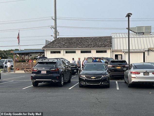 President Joe Biden, in the white shirt (center), leaves Matt's Fish Camp restaurant as part of his date night with Jill Biden