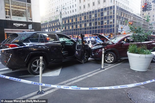 Chaotic images and video from the busy intersection show a black and red vehicle in what appears to have been a head-on collision