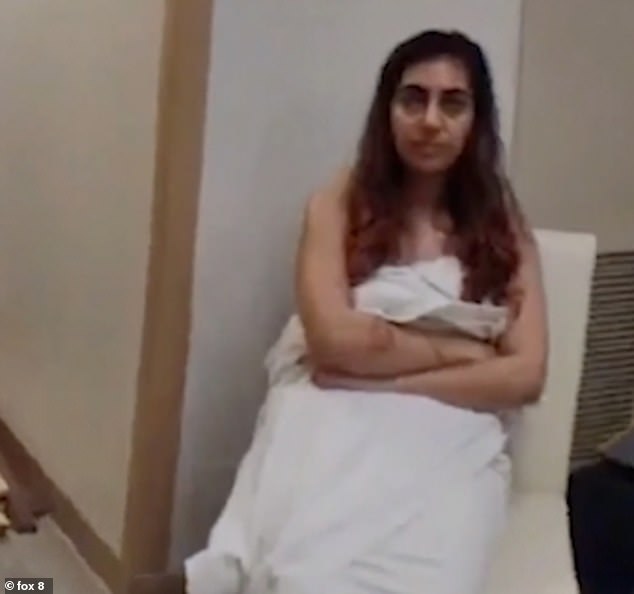 Nikoubin is pictured covering her body with a sheet moments after she was arrested