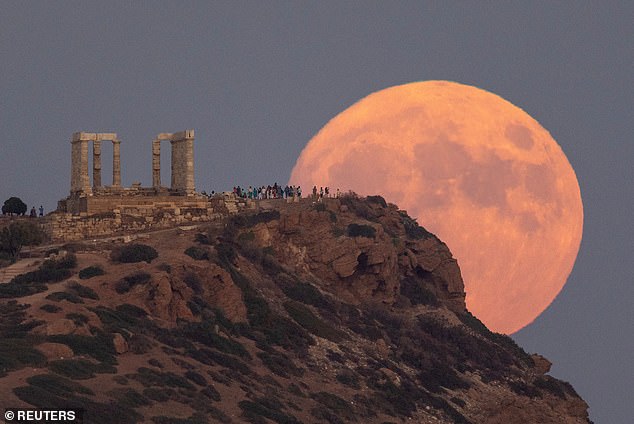 GREECE: A full moon known as the 'Blue Moon' rises behind the Temple of Poseidon, in Cape Sounion, near Athens