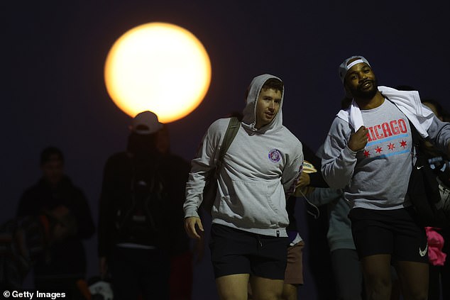 CHICAGO: People gather along North Avenue Beach as a super blue moon rises on August 30, 2023 in Chicago