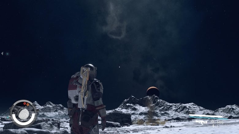 Screenshot of a video game. A person in a spacesuit looks at a rocky barren planet and the space sky.