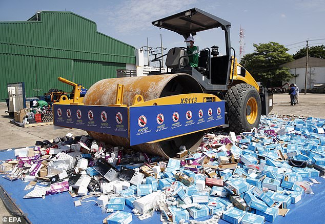 A steamroller crushes counterfeit and license-violating products during a destruction ceremony of goods that infringe intellectual property rights in Bangkok, Thailand, on August 31, 2023