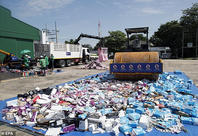 A steamroller crushes counterfeit and license-violating products during a destruction ceremony of goods that infringe intellectual property rights in Bangkok, Thailand, on August 31, 2023