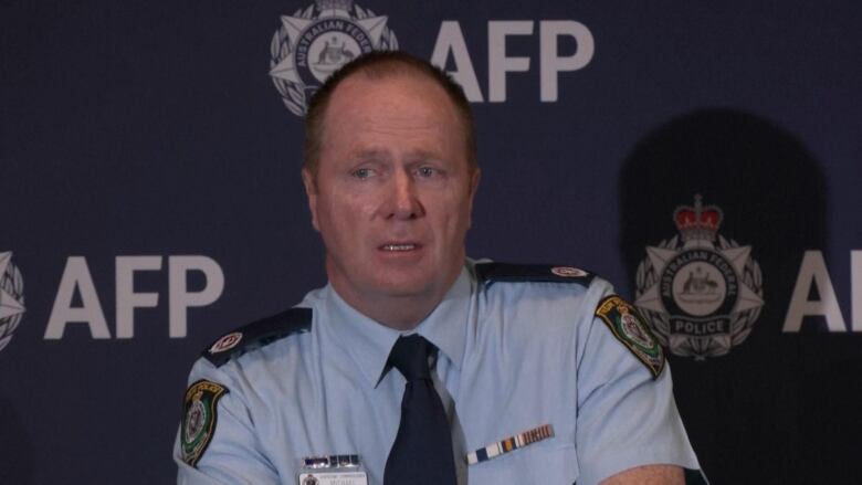 A male police officer speaks at a media briefing.