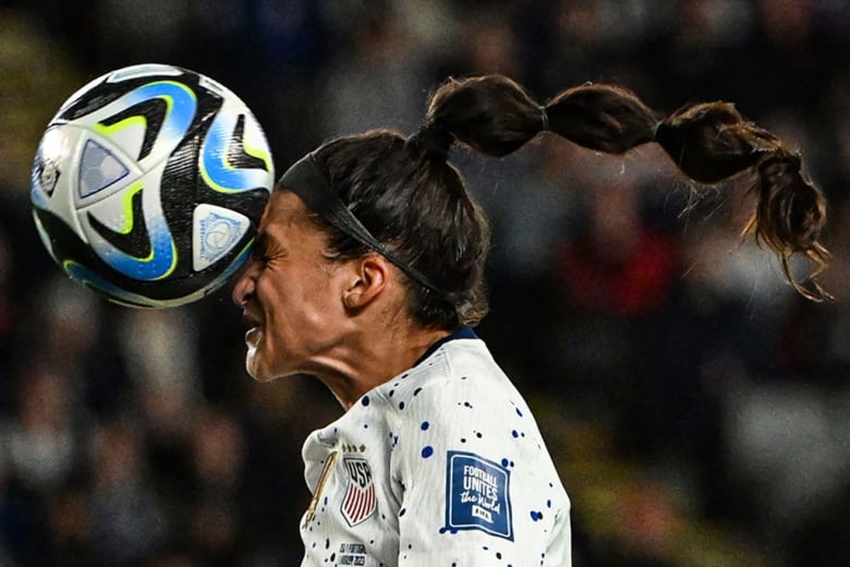 A soccer player heads the ball during the U.S.A.-Portugal match at the Women's World Cup.