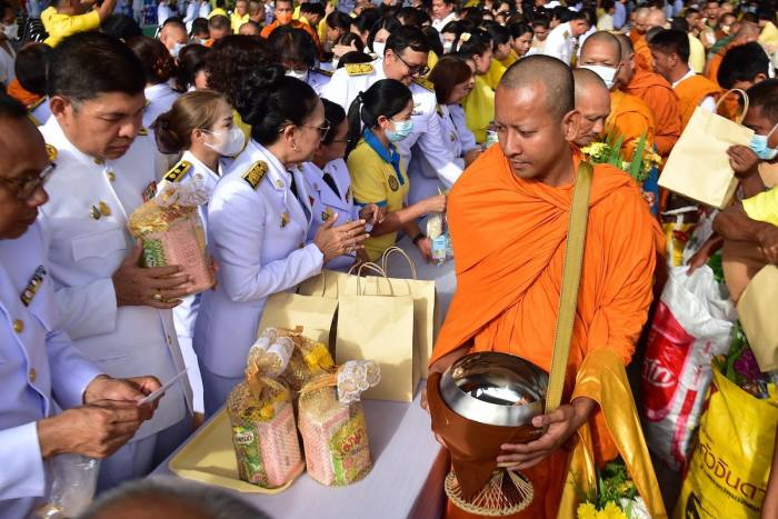 Buddhist monks receive alms in the southern Thailand province of Narathiwat last week