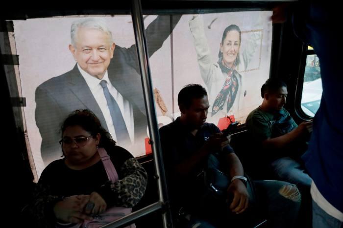 An image of Andres Manuel Lopez Obrador and Claudia Sheinbaum inside a minibus on the streets of Mexico City