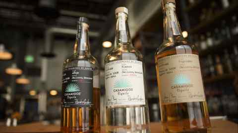 Bottles of Casamigos anejo, blanco, and reposado tequila are arranged for a photograph at a restaurant