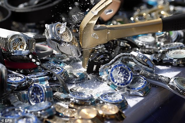 Thai cops destroy a million fake goods worth £13million as ‘Rolex’ watches, ‘Louis Vuitton’ handbags and other replica luxury goods are crushed or chopped up