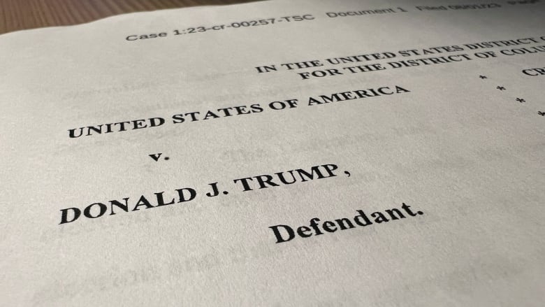 A close up show a legal document that reads, 'United States of America v. Donald J. Trump, defendant.'