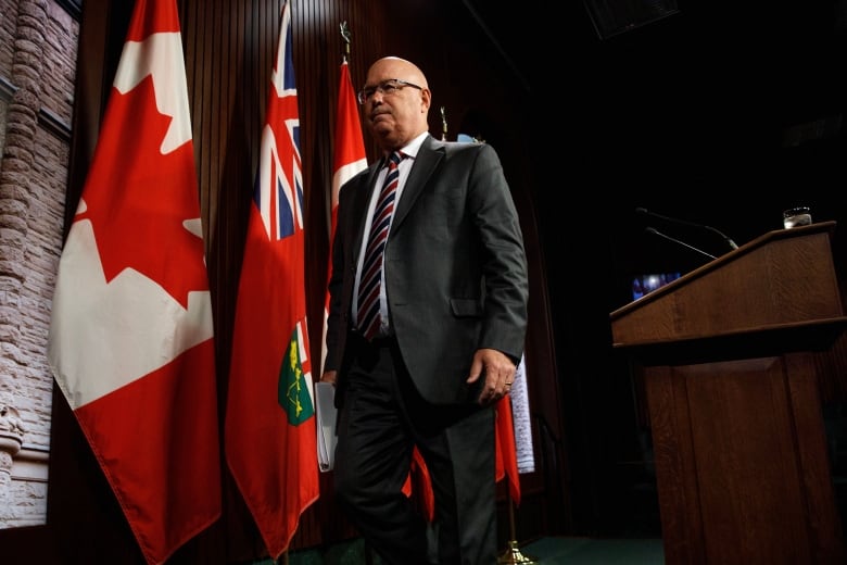 Steve Clark walks away from a podium at Queen's Park.