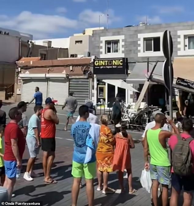 Tourists and locals gathered at the scene where the car had smashed into the bar terrace