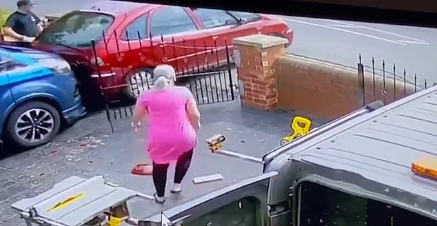 The car smashes through the gate and into a parked vehicle, narrowly missing Mr Duffy who is forced to jump out of the way as the woman whose house he was working on comes to his aid