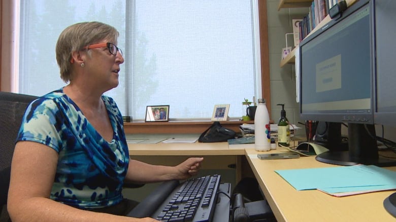 Wanda Martin looks at her computer screen in her office.