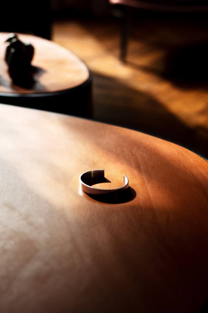 Parente’s Le Gramme silver bracelet on a table from his Apertura collection