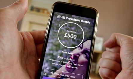 A premium bonds holder celebrates after revealing a £500 prize win on the NS&I app