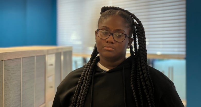 Portrait of a serious teen girl with long braids.