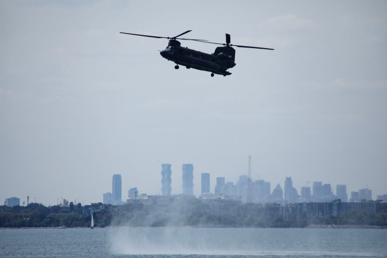 A RCAF CH-146 Griffon helicopter flies near Toronto's lakeshore during practice.